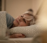 Mature Woman Lying On The Bed And Sleeping At Night.